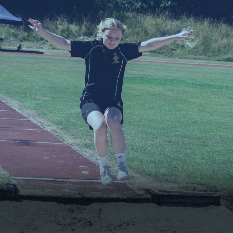 Girl doing long-jump with arms out wide